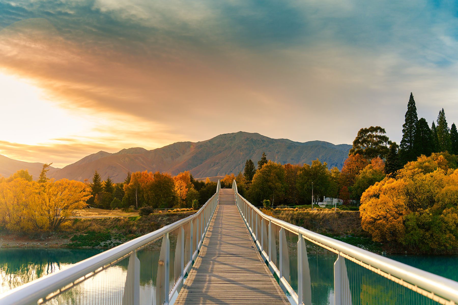 arch-bridge-over-lake-tekapo-in-autumn-forest-at-n-2026-03-25-04-05-02-utc